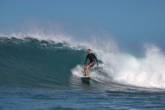 Surfer Executing Smooth Cutback On Glassy Wave Face