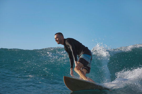 Surfer Committing To Steep DropIn On Fast Face