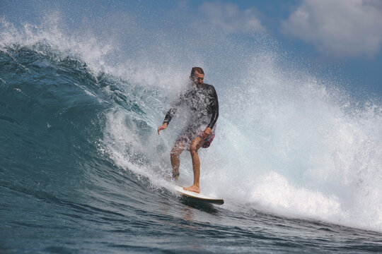 surfer Executing Smooth Cutback On Glassy Wave Face