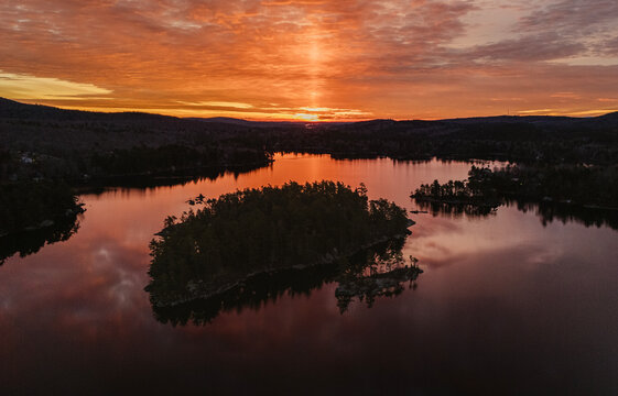 Vibrant colorful sunrise over islands in Phillips Lake, Maine