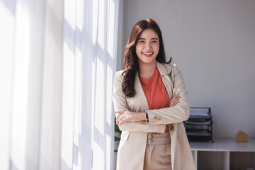 Fototapeta premium Confident young asian businesswoman smiling in office