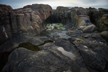 Exploring rocky coastal landscape in Teriberka, Russia during a cloudy day