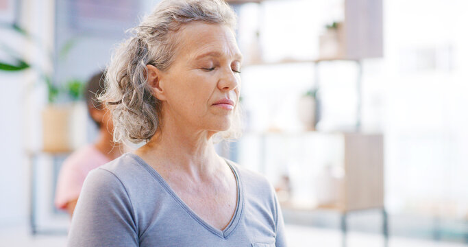 Yoga class, senior woman and meditation for calm, mindfulness or fitness with breathing exercise. Yogi, spiritual wellness and person with friends in studio, zen or balance for health in retirement - Powered by Adobe