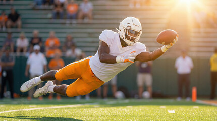 American football player making a spectacular diving catch during a game. Wide receiver in white and orange uniform flying through the air to score a touchdown at sunset.