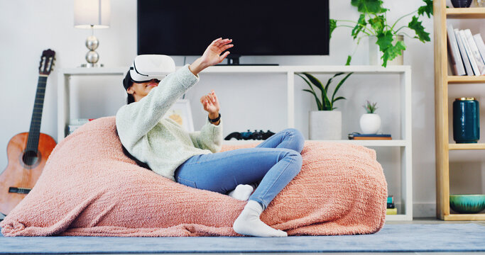 Girl, play and vr headset at house for streaming, digital interaction or gaming for 3D experience. Female person, relax and virtual reality glasses to explore metaverse, simulation and entertainment - Powered by Adobe