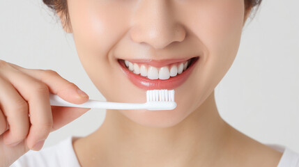 A photo of a beautiful woman holding a toothbrush, about to brush her teeth