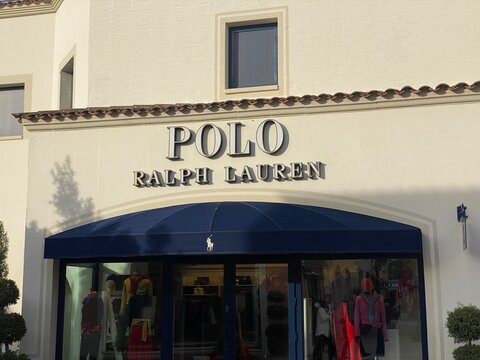 Mallorca, Spain - December 7: Polo ralph lauren store facade at mallorca fashion outlet, featuring the main entrance, blue awning, and mannequins showcasing luxury apparel in the storefront
