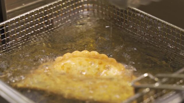Delightful chebureki frying experience captured in close-up detail