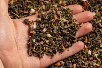 a large amount of dried green tea with the addition of natural flavors and pieces of fruits and berries, green tea with the addition of taste and smell of other sweet foods