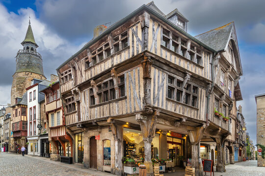Historic half-timbered houses and clock tower in the medieval town of Dinan, Brittany, France