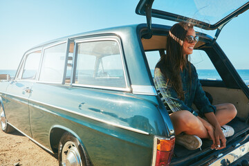 Naklejka premium Car, trunk and woman with road trip at beach for travel adventure, journey pause and sightseeing. Sunglasses, happy girl and relax in vehicle for weekend getaway, explore or fresh air with ocean view