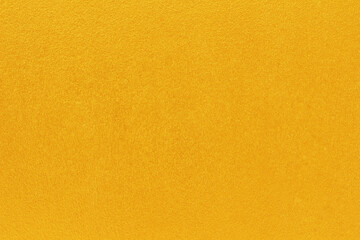 Gold or yellow paint on cement wall texture  background.
