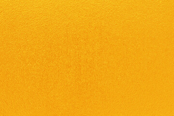 Gold or yellow paint on cement wall texture  background.