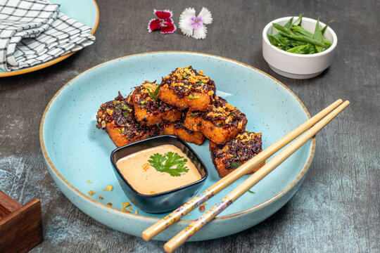 Crispy fried turnip cake made from grated radish and seasonings, served as a classic Chinese dim sum dish. Known for its golden crust and soft interior, this popular appetizer is ideal for restaurant 