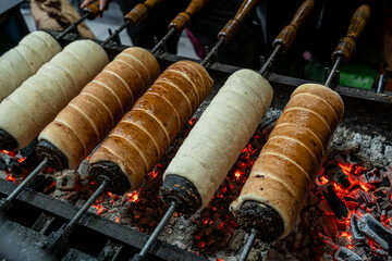 Hungarian chimney cake or k&uuml;rtőskal&aacute;cs wrapped around a truncated cone&ndash;shaped baking spit, and rolled in granulated sugar. It is roasted over charcoal until it's brown. Chimney cake is a Hungarikum.