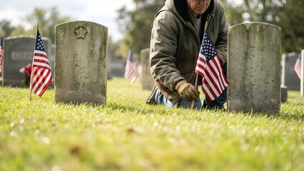 Man placing American flags on graves.