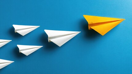 Paper airplanes leadership concept against a blue background business vision