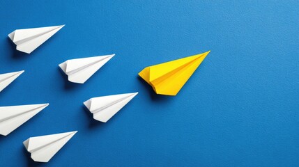 Paper airplanes leadership concept against a bright blue background