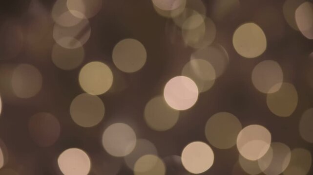 Soft golden bokeh lights create a warm, festive atmosphere. The background is blurred, enhancing the dreamy effect of the light spots.