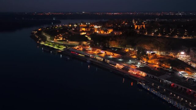Aerial drone view of Kalemegdan Fortress illuminated in warm lights at night