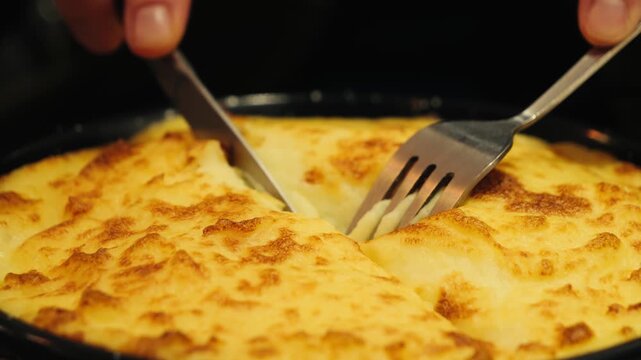 Duck Parmentier or Parmentier de Canard is a classic, hearty casserole from France, using shredded duck confit under a creamy mashed potato topping. High quality 4k footage