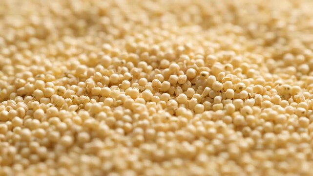 Close-up shot of tiny light brown puffed cereal grains forming a textured background