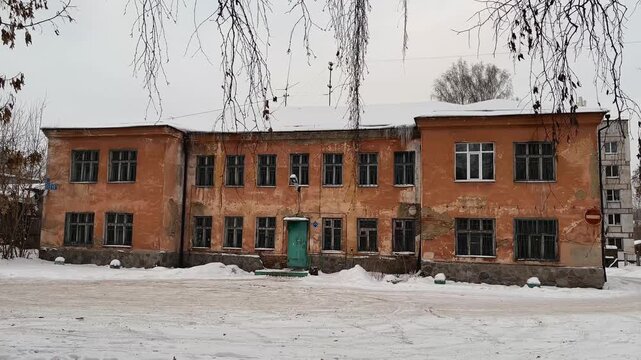 Old Orange Two-Story Building Exterior in Winter Overcast Weather