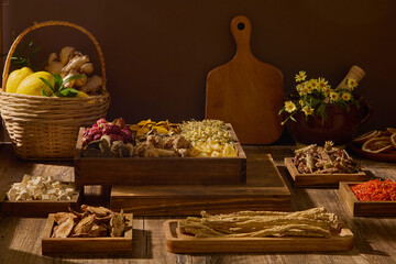 Creative scene showing wooden boards, herbs, and small containers on brown background. Traditional herbal preparation and handcrafted wellness products