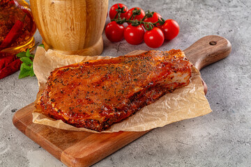 Raw marinated pork loin steak