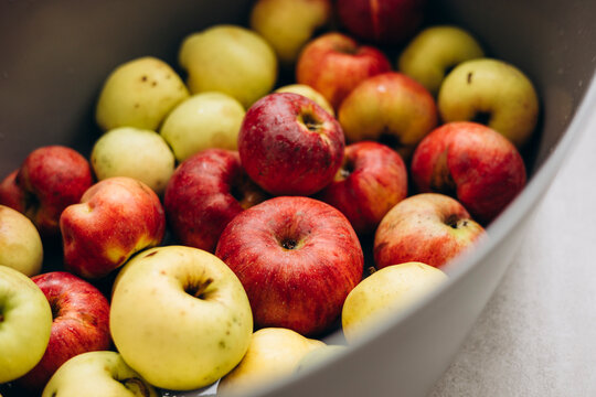 Rustic imperfect apples in bowl, natural farm fruit.