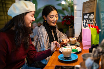 Friends exchanging christmas gifts and sharing coffee