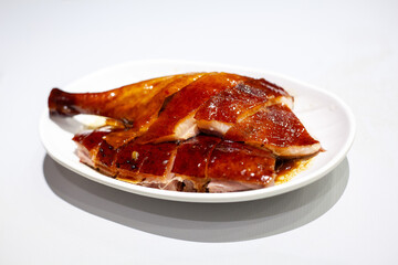 Hong Kong Cantonese style roast goose drumstick on white background