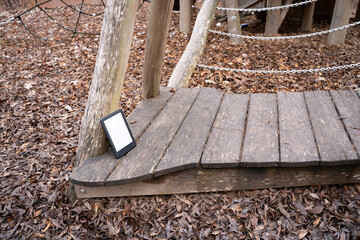 Ebook lying on wooden playground construction