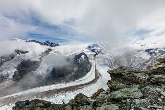 Panorama of stunning mountains and glaciers above, Switzerland.