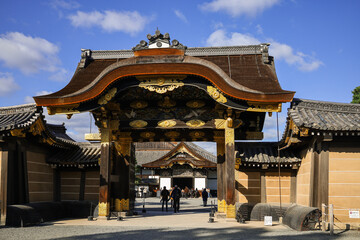 Fototapeta premium Kyoto. Ancient Japanese Temple Gate With Ornate Wooden Archway And Traditional Tiled Roof In Sunlight Today