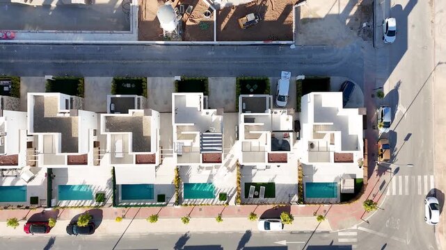 Top-down view of villas with pools and terraces