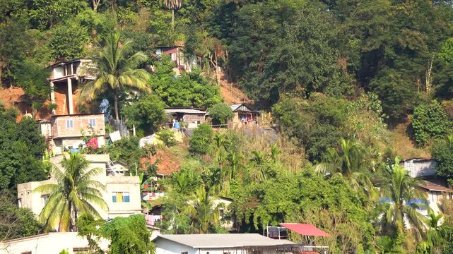 Pan shot of unsafe building and house construction on hill slopes in Guwahati Assam India