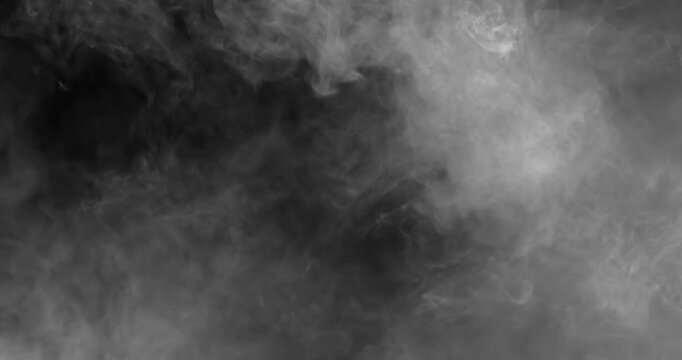 black and white smoke explosion slowly floating through space against black background