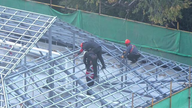 Migrant farmers working on construction site, Beijing, China.