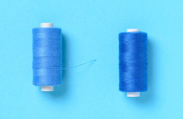 Blue thread spools background with copy space for text close-up flat lay top view