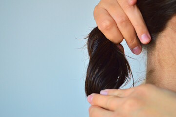 Close-Up of Hands Holding Thick Healthy Dark Brown Hair Bundle for Hair Quality Concept