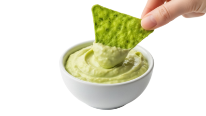 Isolated image of a green tortilla chip being dipped into a bowl of fresh guacamole dip