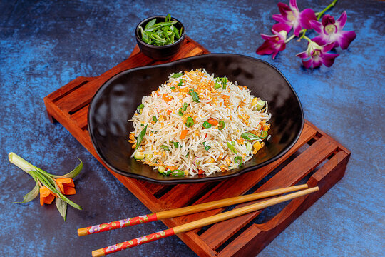 Fragrant fried rice tossed with fresh vegetables and infused with the rich, aromatic flavor of burnt garlic. A popular vegetarian Asian dish known for its savory taste, smoky undertone, and colorful p