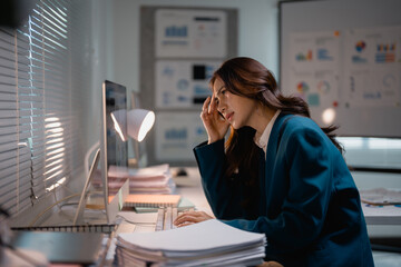 Businesswoman experiencing headache working late at office