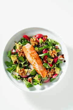 Nutritious Green Salad with Fried Salmon, Avocado and Nuts