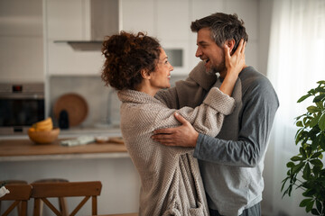 Couple Embracing in Cozy Home Kitchen, Happy Moment of Love and Connection