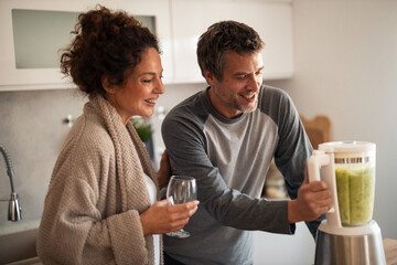 Happy Couple in Modern Kitchen Blending Healthy Green Smoothie Together for Morning Wellness