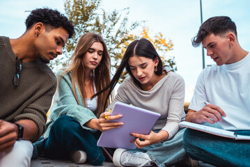 Diverse students collaborating on study group outdoors