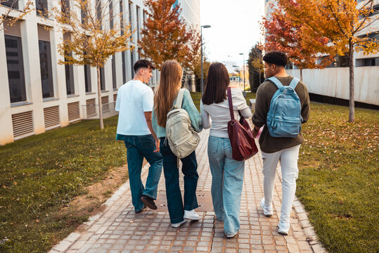 Diverse students walking campus during autumn
