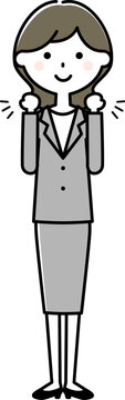 ガッツポーズをするスーツの女性　ファイティングポーズ